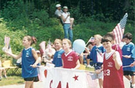Children holding a CAA sign on parade